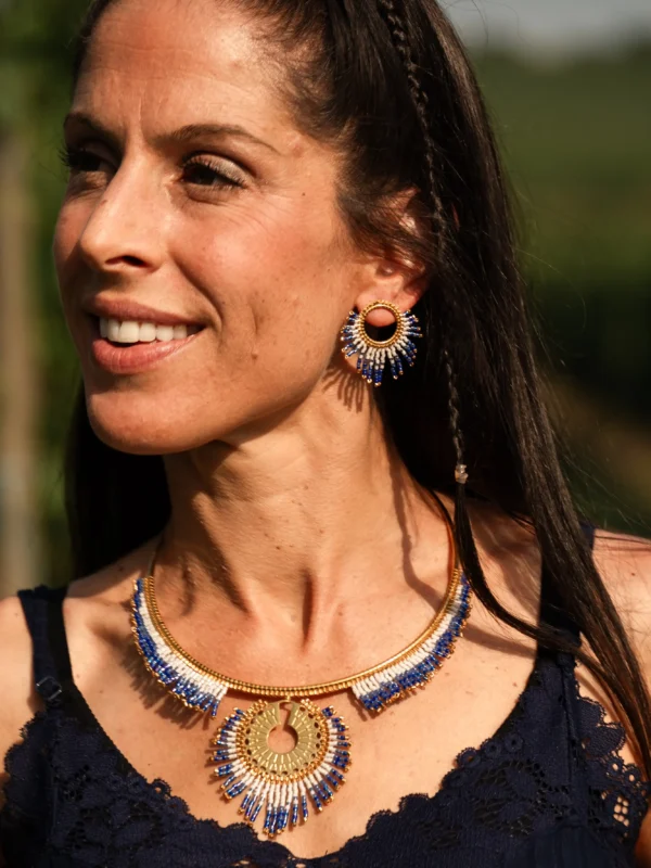 boutique-valdyria-mira-obscura-petites-boucles-oreilles-portrait-lumineux Petites boucles d’oreilles Mira Obscura en perles Miyuki bleues et dorées, portées avec collier majestueux assorti. Bijoux artisanaux français, faits main en Alsace, créations écoresponsables et inspirées des astres.