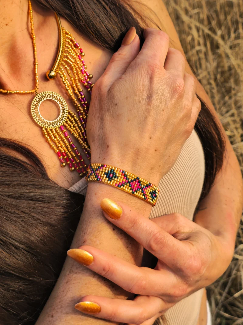 Bracelet Amaziga Rubra et héritage féminin Bracelet Amaziga Rubra porté au poignet avec perles roses et détails dorés artisanaux