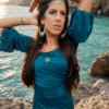 Boucles d’oreilles pendantes Mira Calypsa portées en portrait avec robe bleue et bijoux faits main Valdyria