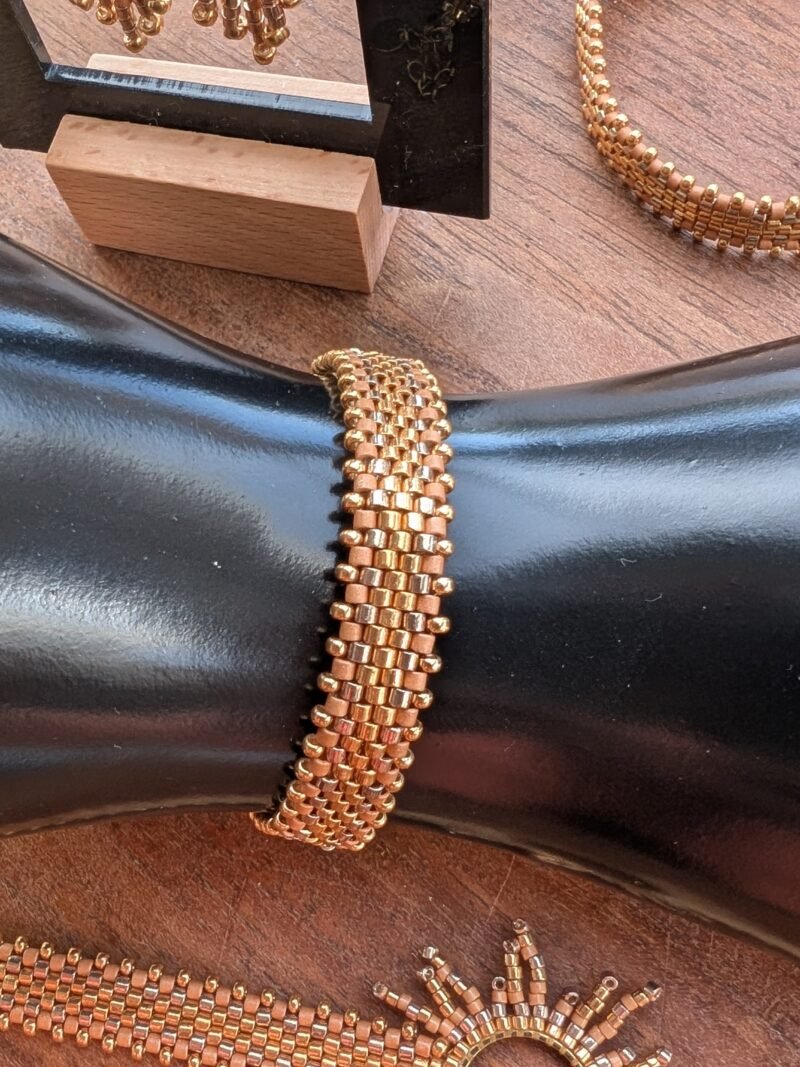 Bracelet Apollisia Solaris et lumière dorée Bracelet Apollisia Solaris doré présenté en gros plan, bijou artisanal Valdyria en perles Miyuki aux reflets solaires